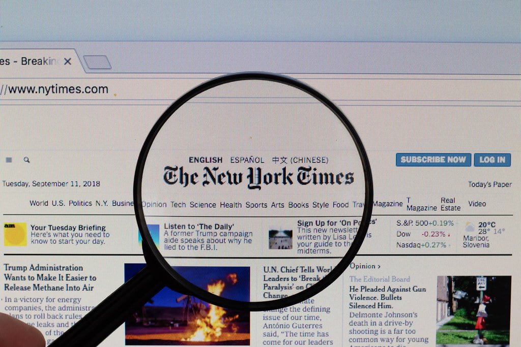 The New York Times logo on a computer screen with a magnifying g